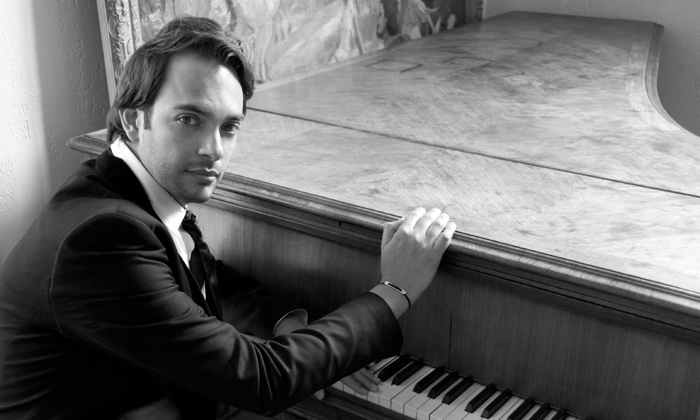 The pianist and composer Christophe Diès sitting at the piano